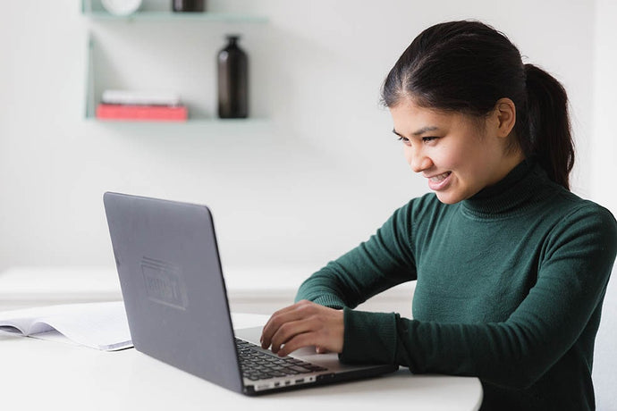 Happy woman using document management software on the office computer